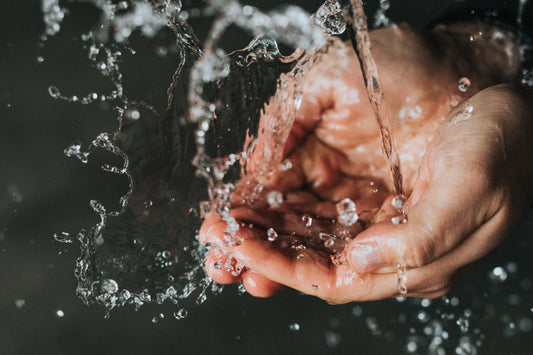 Woman Taking A Shower With hai Water Saving Shower Head