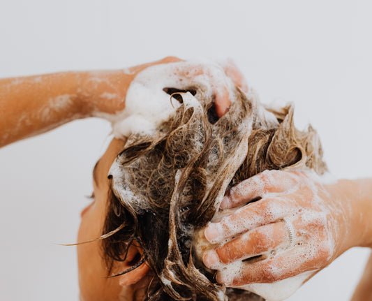 A woman washing your hair | Shower Routine For Brown Hair 